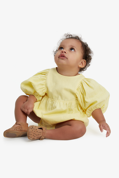 Baby in yellow dress on sale